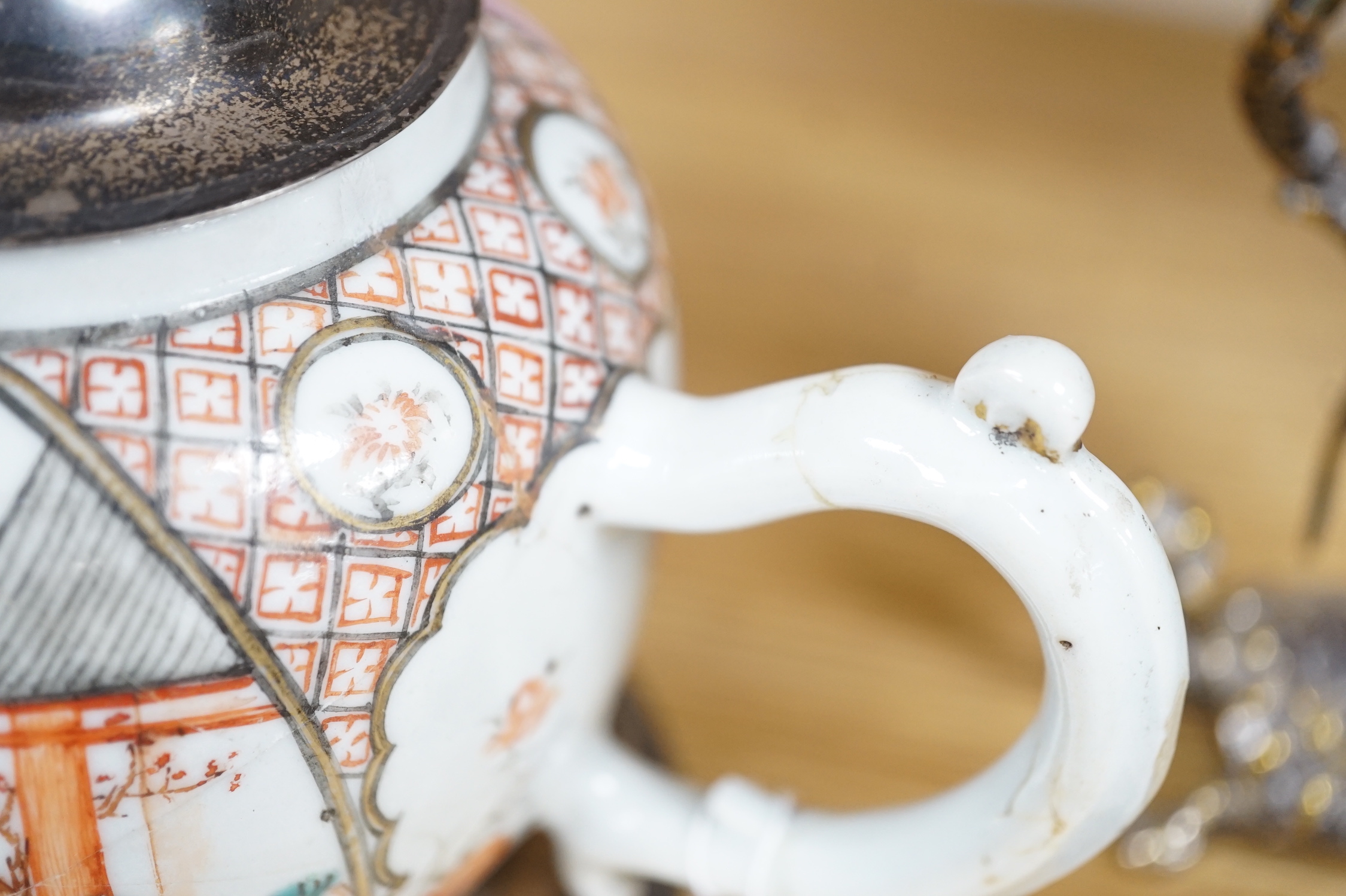 An 18th century Chinese export famille rose teapot with later silver spout and cover, on hardwood stand